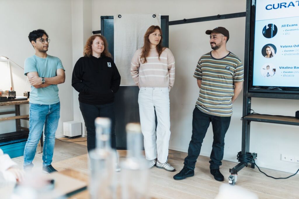 A team of diverse individuals presenting at a business meeting in a modern office setting.